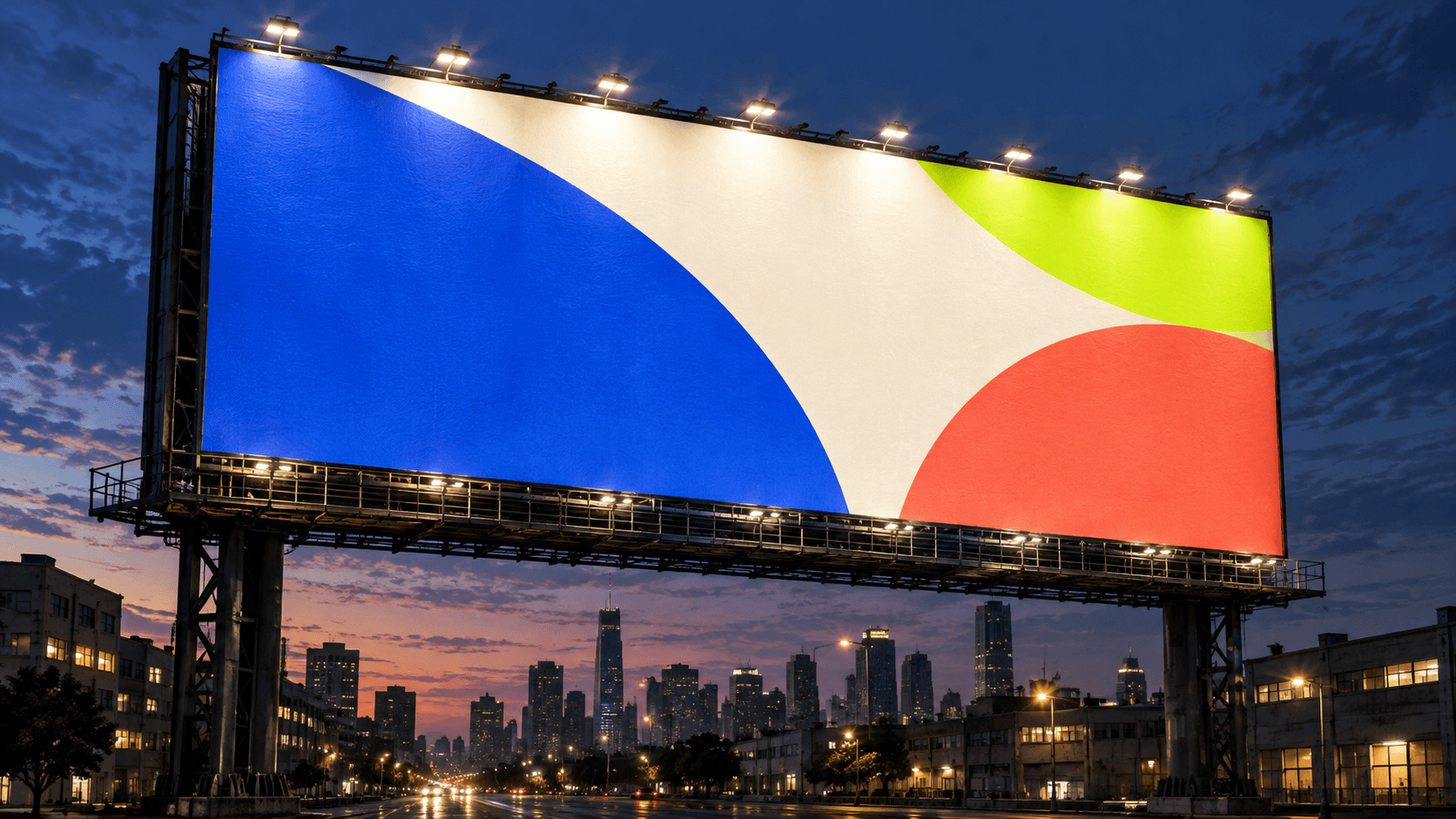 A giant illuminated billboard towering over a city at blue hour